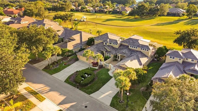 an aerial view of residential houses with outdoor space