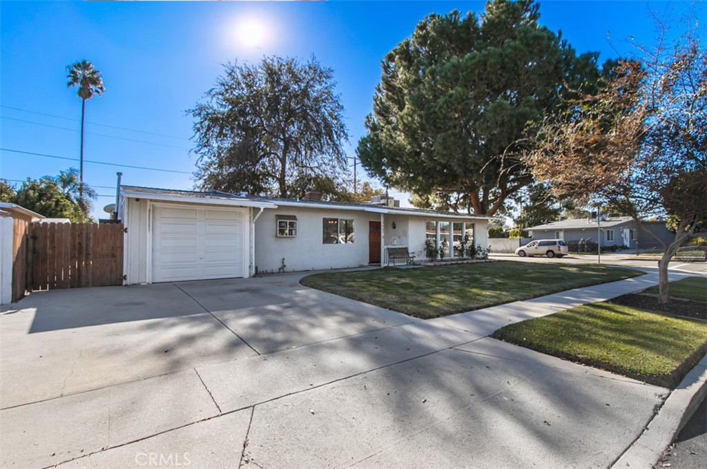 19462 Arminta Street Reseda, CA 91335 - Photo 1 of 1 a view of a house with a yard and potted plants