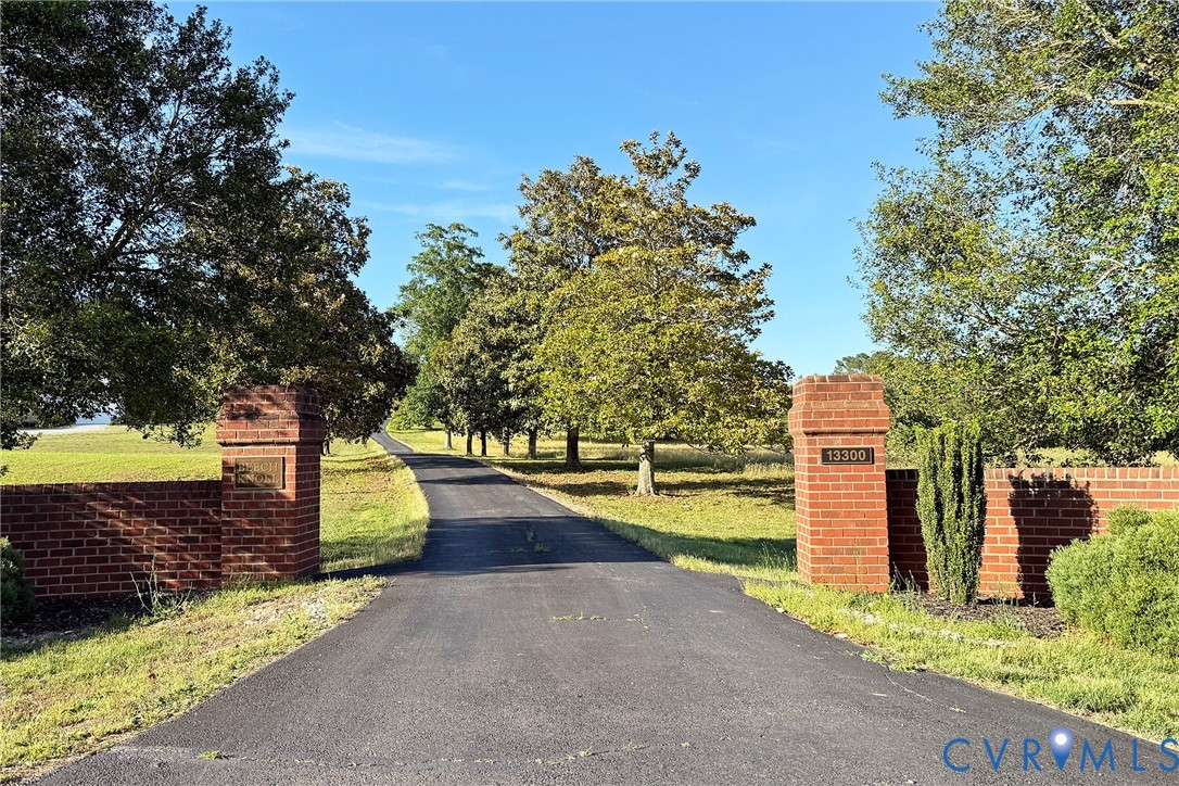 13300 West Patrick Henry Road Doswell, VA 23047 - Photo 69 of 69 Paved drive entry featuring brick pillars, a brick