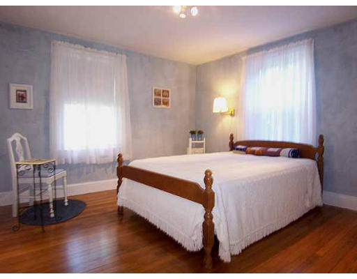 74 Ely Avenue West Springfield, MA 01089 - Photo 11 of 22 a bedroom with a bed a chair and potted plant with the dresser