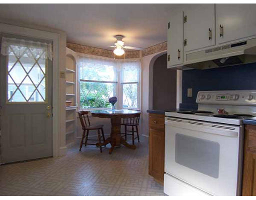 74 Ely Avenue West Springfield, MA 01089 - Photo 5 of 22 a kitchen with stainless steel appliances granite countertop a stove a refrigerator a dining table and chairs with wooden floor