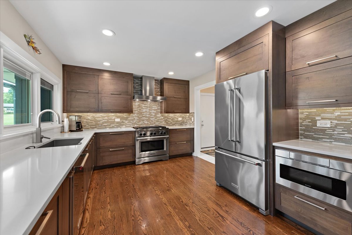 5908 Edgewood Road Crystal Lake, IL 60012 - Photo 11 of 60 a kitchen with stainless steel appliances a refrigerator sink and stove