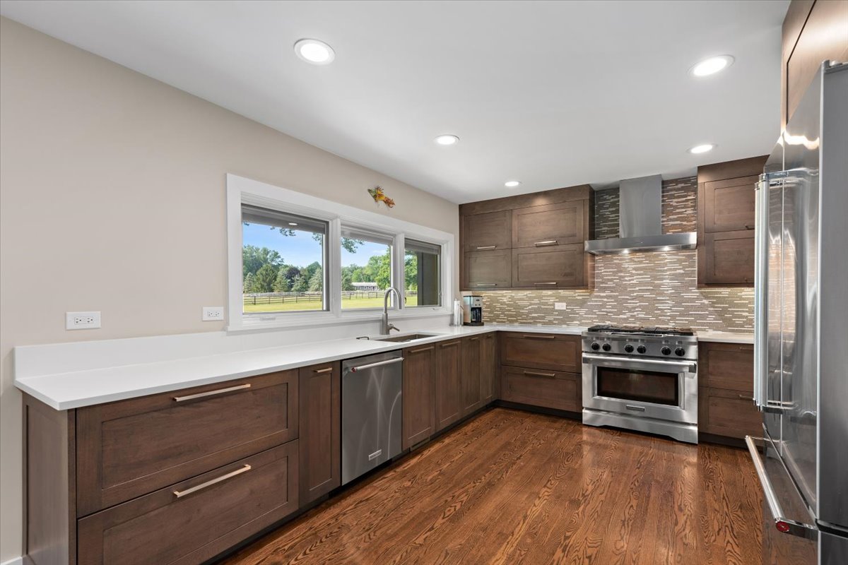 5908 Edgewood Road Crystal Lake, IL 60012 - Photo 12 of 60 a large kitchen with a stove and a sink