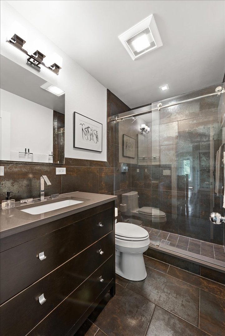 5908 Edgewood Road Crystal Lake, IL 60012 - Photo 20 of 60 a bathroom with a double vanity sink toilet and shower
