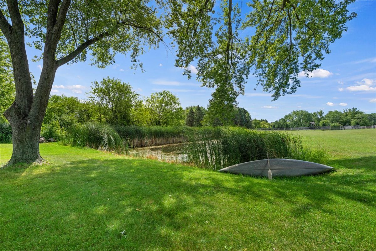 5908 Edgewood Road Crystal Lake, IL 60012 - Photo 31 of 60 a view of a lake with a big yard and potted plants and large trees