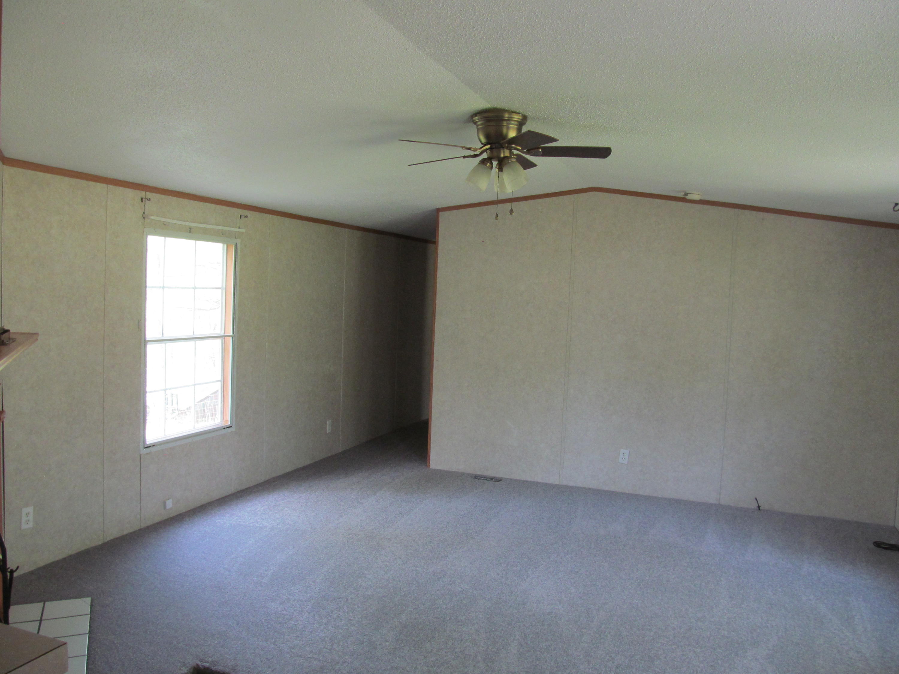 312 Piney Branch Road Blue Ridge, VA 24064 - Photo 2 of 21 an empty room with windows and fan