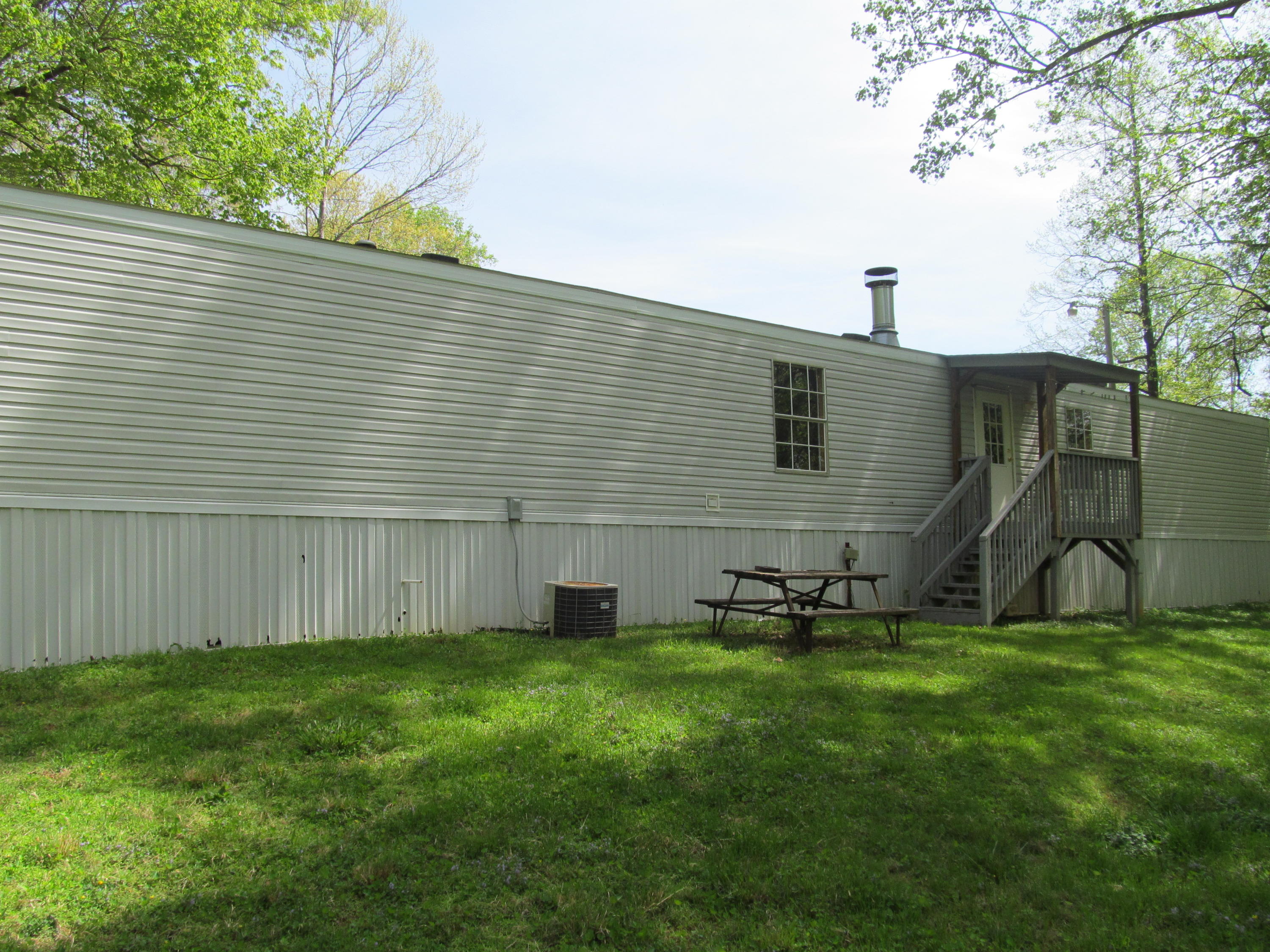 312 Piney Branch Road Blue Ridge, VA 24064 - Photo 17 of 21 a view of a backyard with plants and a large tree