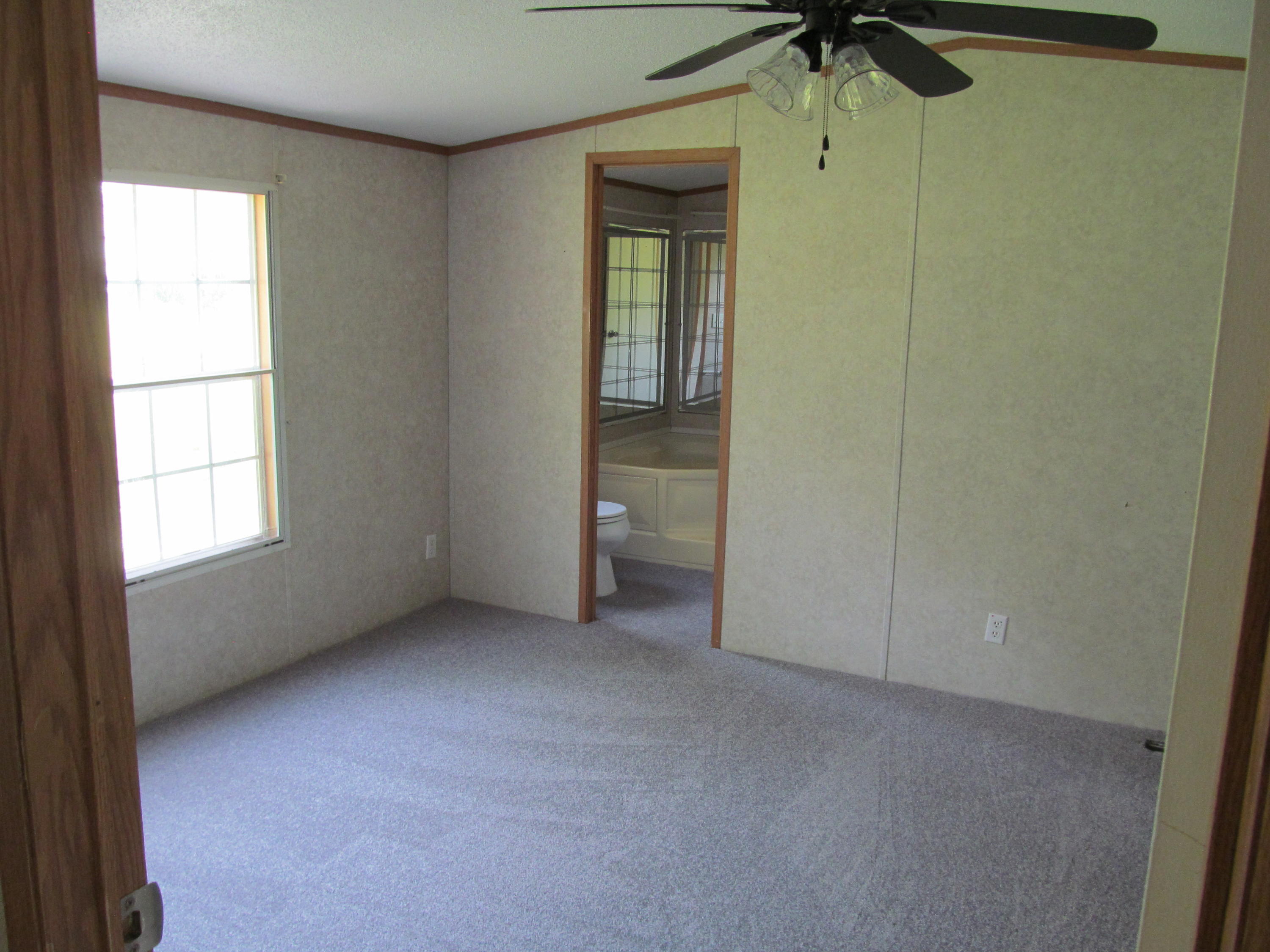 312 Piney Branch Road Blue Ridge, VA 24064 - Photo 8 of 21 an empty room with a window and a fan
