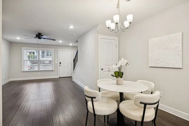 a view of a dining room with furniture wooden floor and chandelier