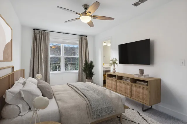 a bedroom with a bed and a flat screen tv