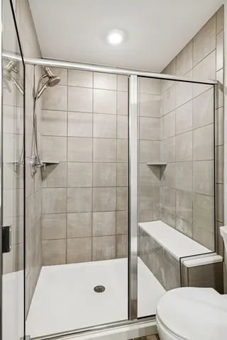 a bathroom with a shower and a toilet