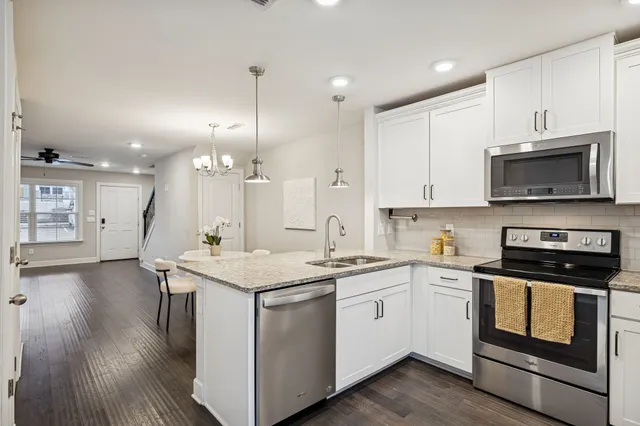 a kitchen with a sink stove and microwave