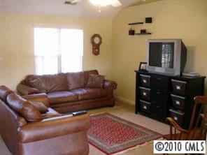6922 Sullins Road Charlotte, NC 28214 - Photo 2 of 8 a living room with furniture and a flat screen tv