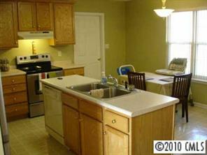 6922 Sullins Road Charlotte, NC 28214 - Photo 4 of 8 a kitchen that has a sink and a stove in it