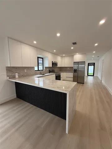 a kitchen with stainless steel appliances granite countertop a sink counter space and cabinets