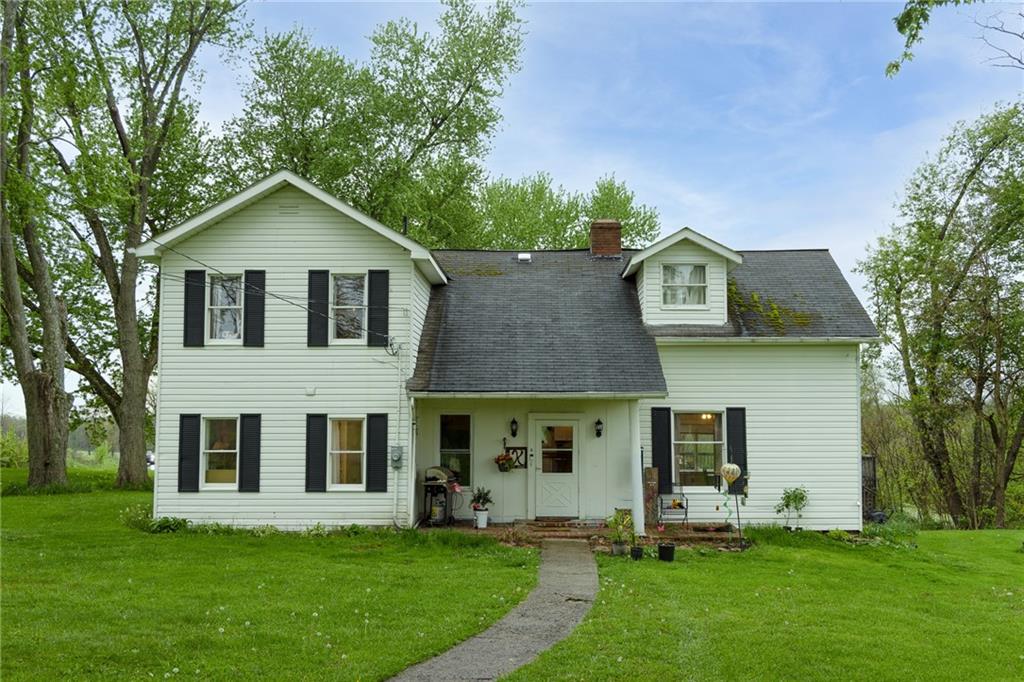 a front view of house with yard and green space