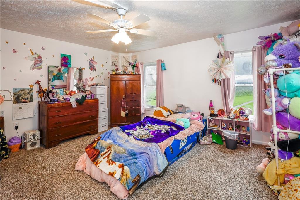 285 Poole Road Mercer, PA 16137 - Photo 26 of 43 a bedroom with bed and a chandelier
