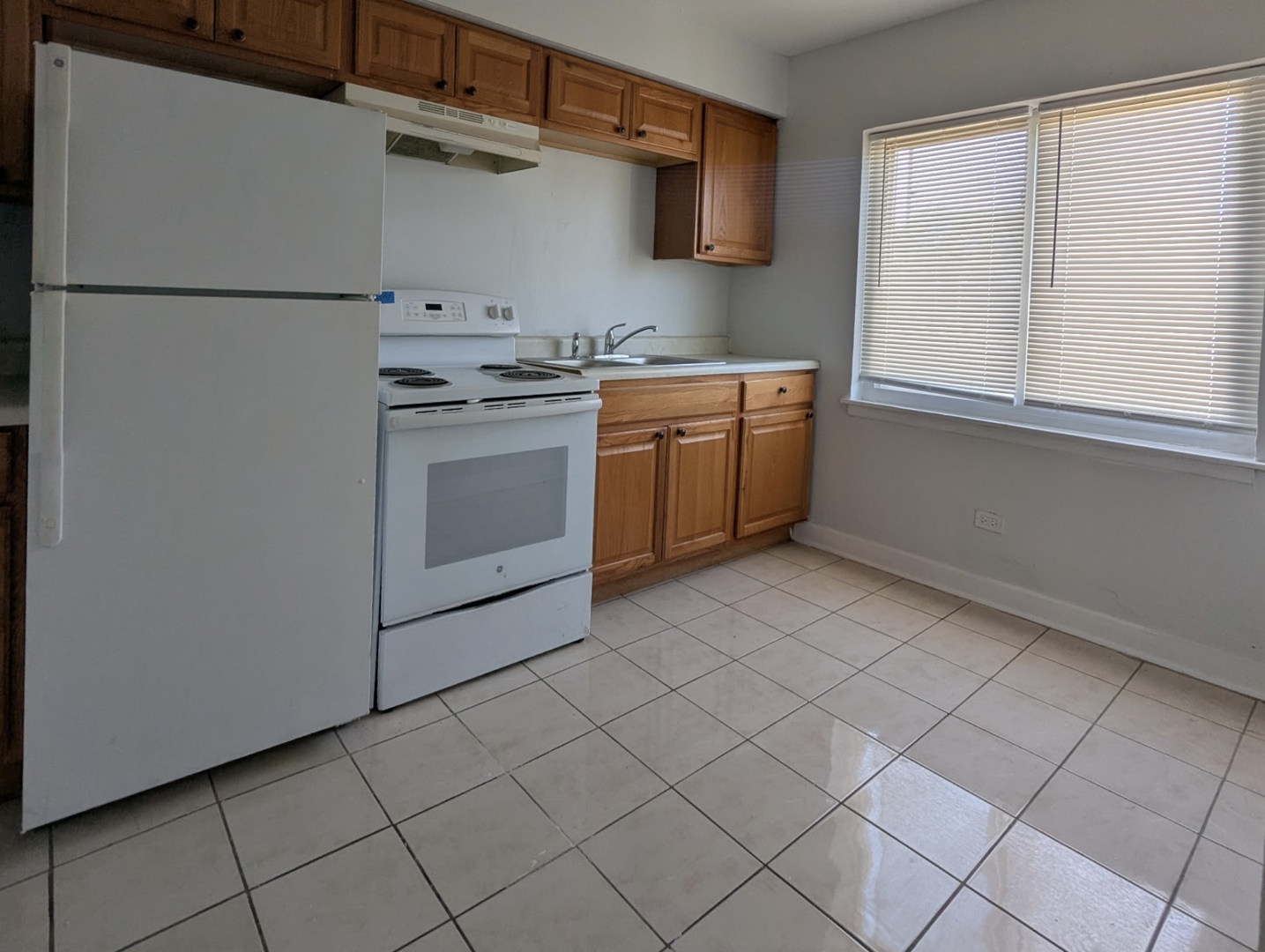 7201 South Western Avenue, Unit 72017 Chicago, IL 60636 - Photo 5 of 6 a kitchen with a stove a sink and a refrigerator