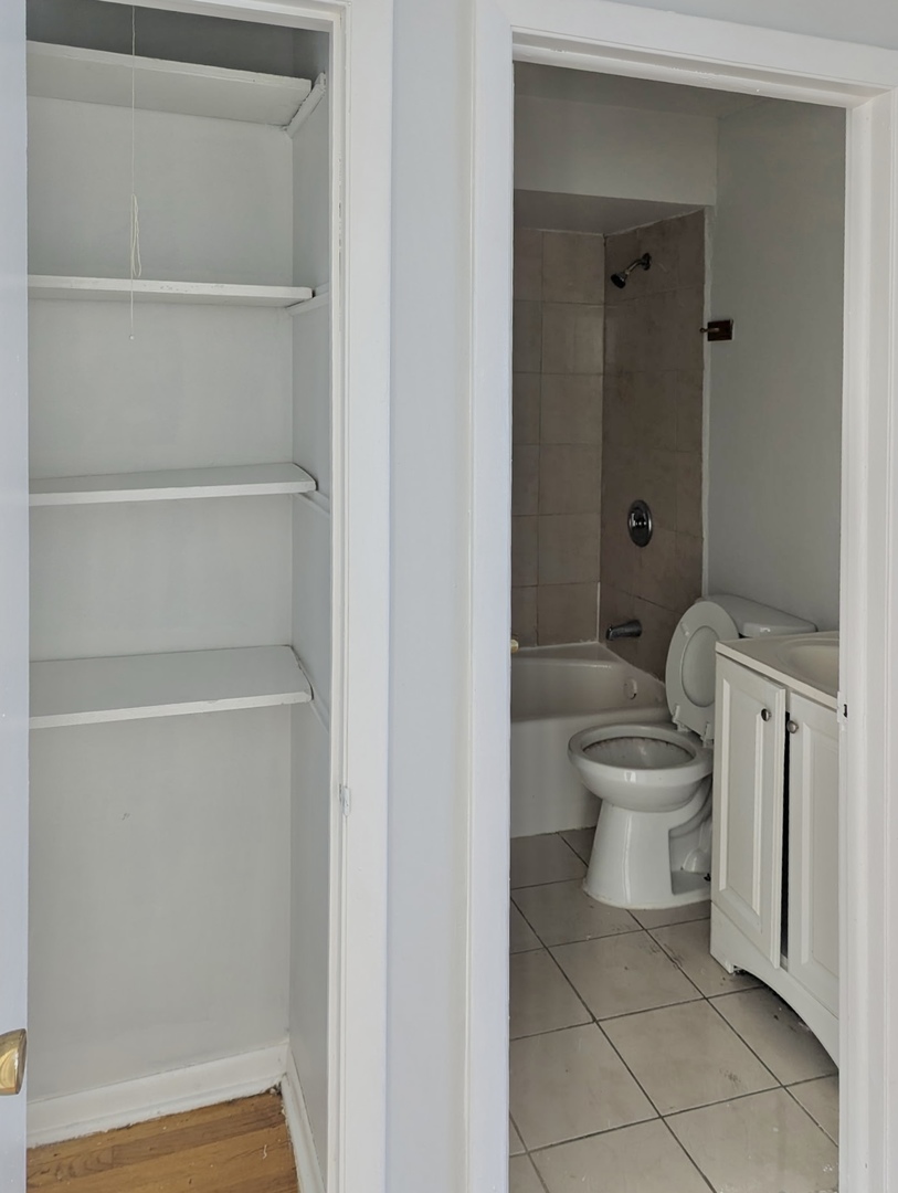7201 South Western Avenue, Unit 72017 Chicago, IL 60636 - Photo 6 of 6 a white toilet sitting next to a bathroom sink