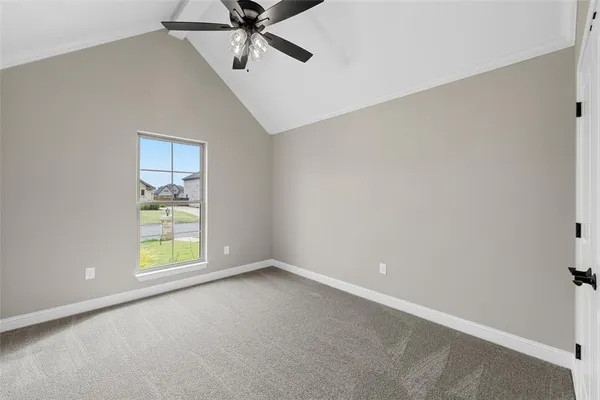 a view of an empty room with a ceiling fan