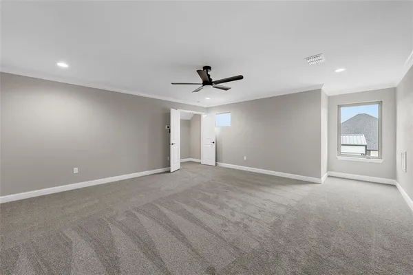 a view of an empty room with a ceiling fan