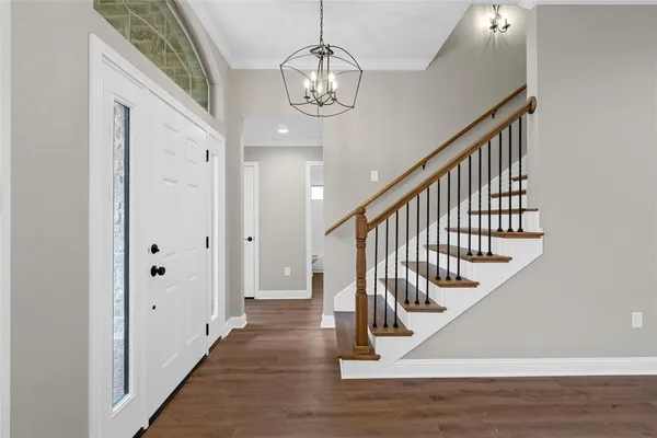 a view of entryway and hall with wooden floor