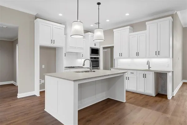 a kitchen with a sink stove and refrigerator