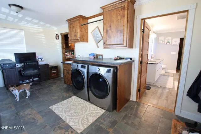 a utility room with sink dryer and washer