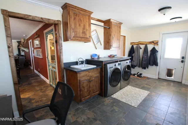 a utility room with sink dryer and washer