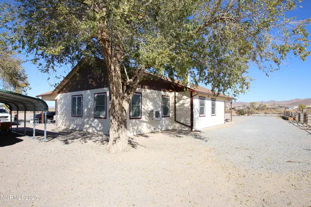 a view of a house with snow on the road