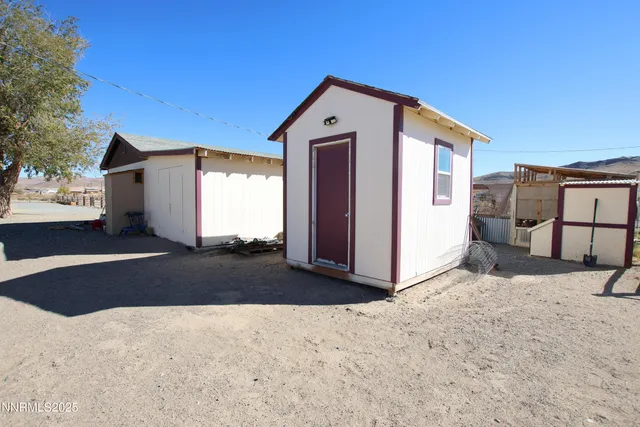 a view of a house with a snow in the background