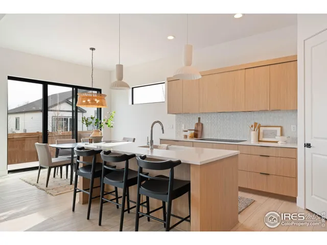 a kitchen with appliances cabinets and dining table
