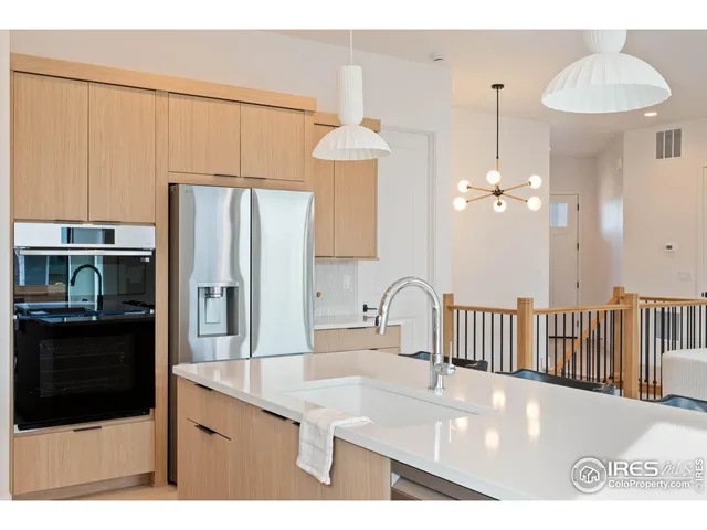 a kitchen with a sink a refrigerator and a stove