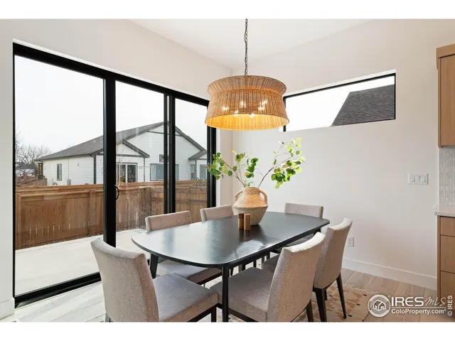 a dining room with furniture a potted plant and a chandelier