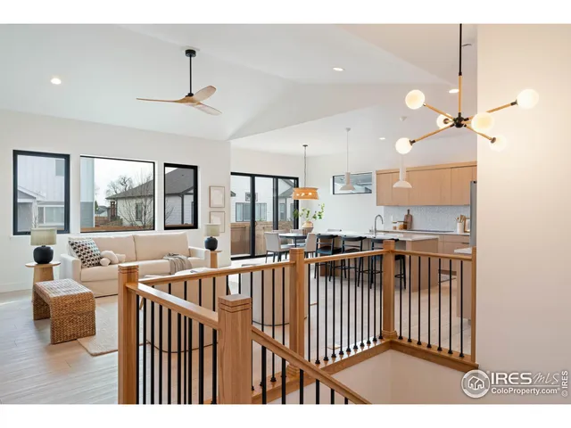 a living room with fireplace furniture and a large window