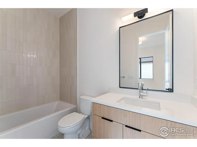 a bathroom with a sink a toilet and bathtub