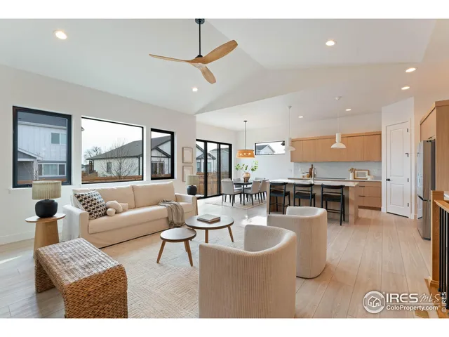 a living room with fireplace furniture and a large window
