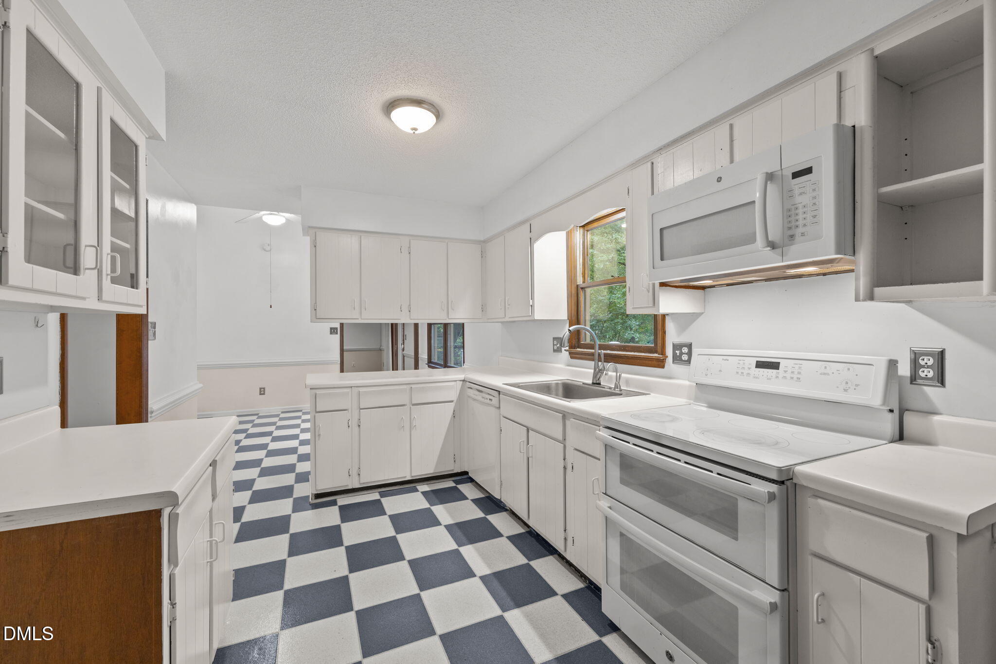 2713 Salisbury Plain Raleigh, NC 27613 - Photo 16 of 39 a kitchen with a sink a stove and cabinets