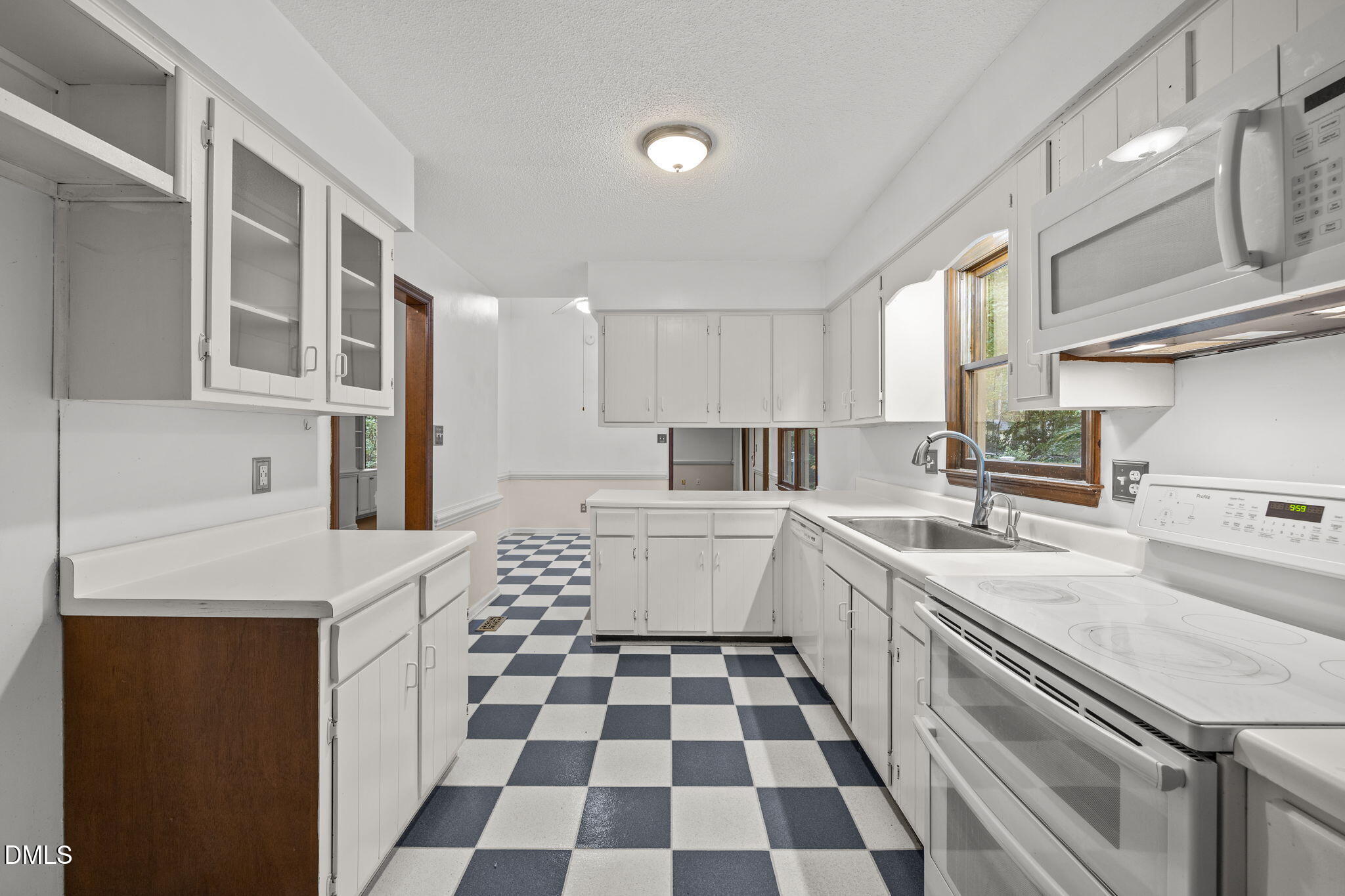 2713 Salisbury Plain Raleigh, NC 27613 - Photo 18 of 39 a kitchen with a sink a stove and a refrigerator