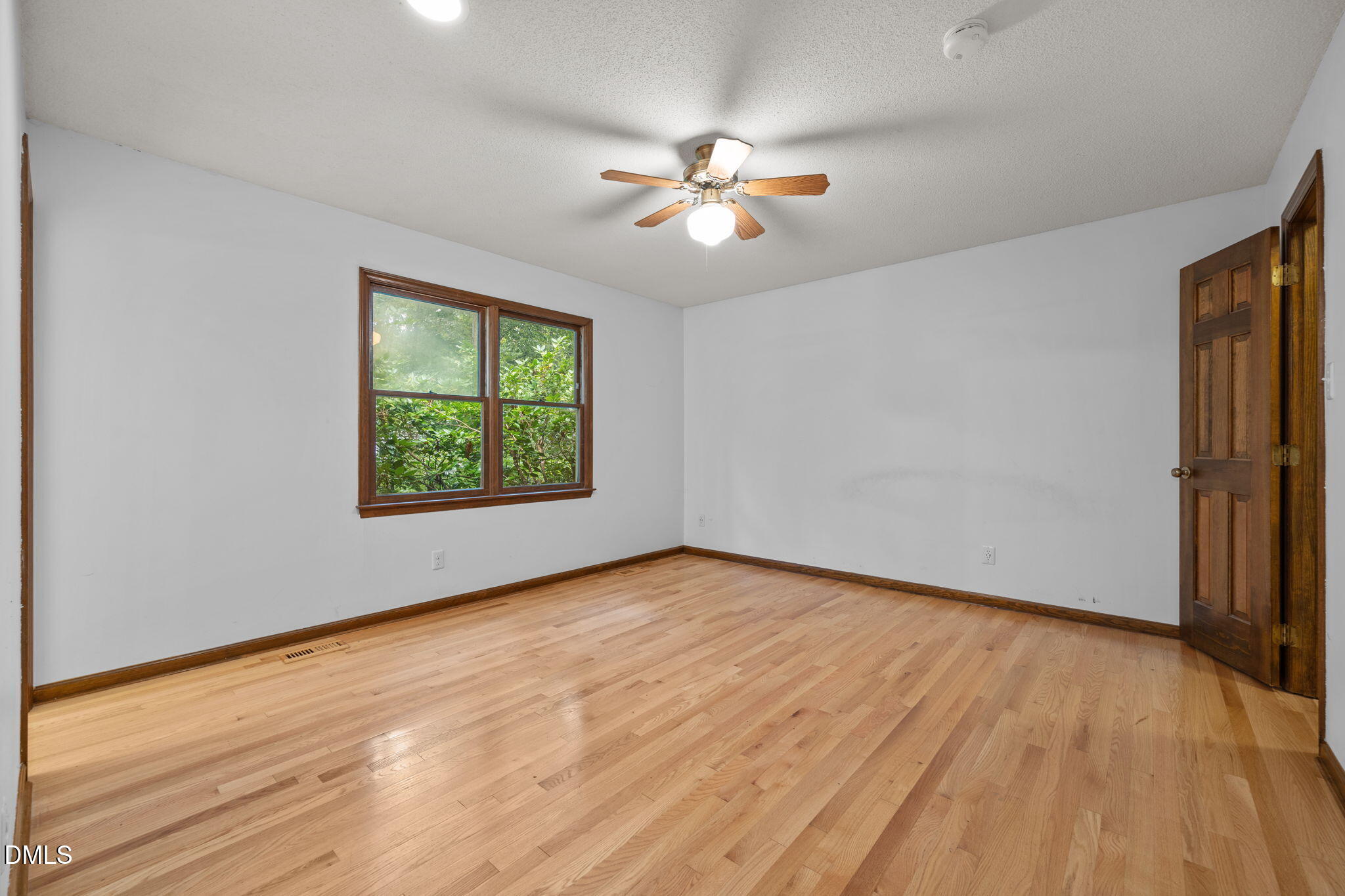 2713 Salisbury Plain Raleigh, NC 27613 - Photo 22 of 39 wooden floor in an empty room with a window
