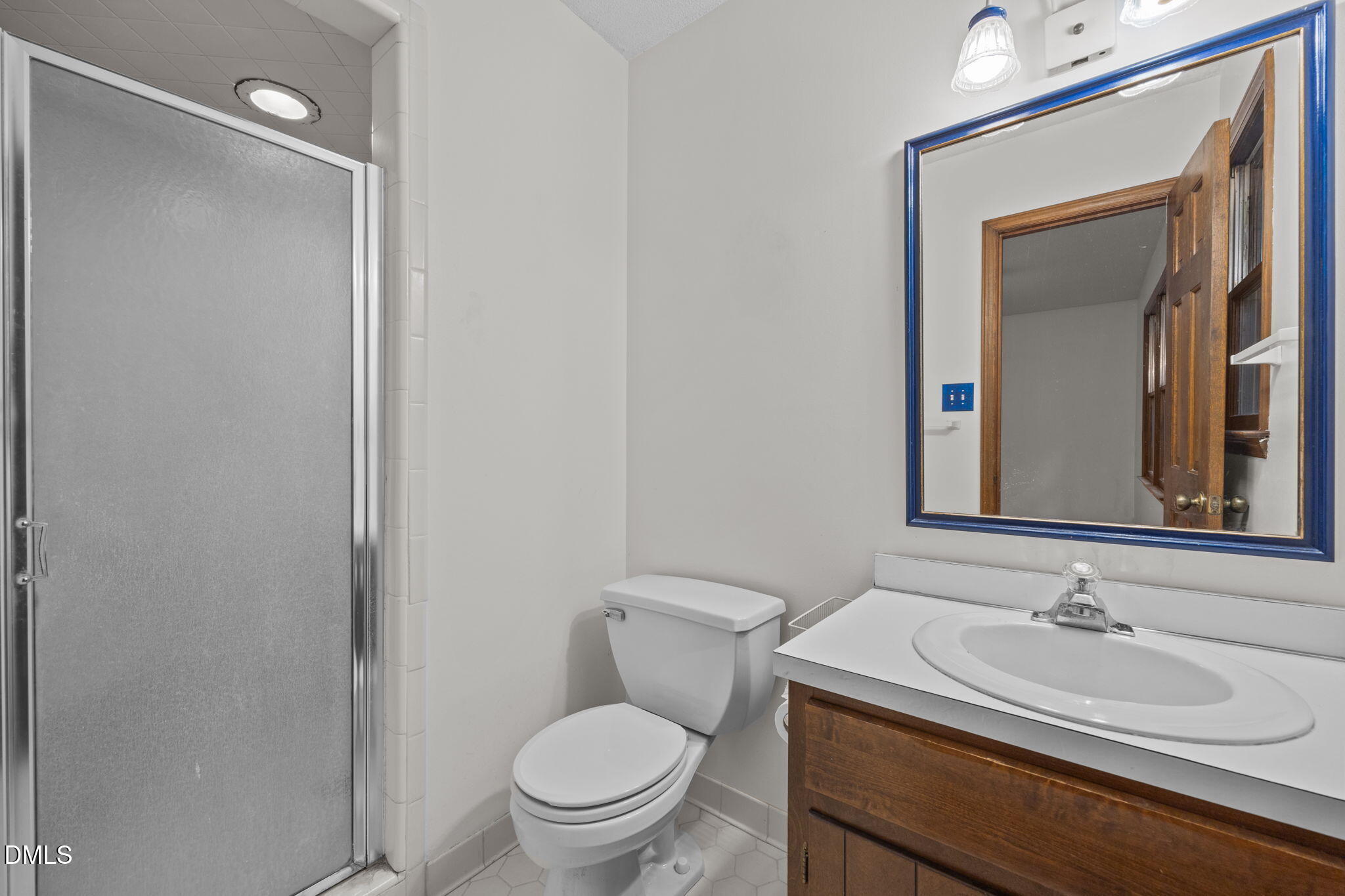 2713 Salisbury Plain Raleigh, NC 27613 - Photo 24 of 39 a bathroom with a toilet sink vanity granite and mirror