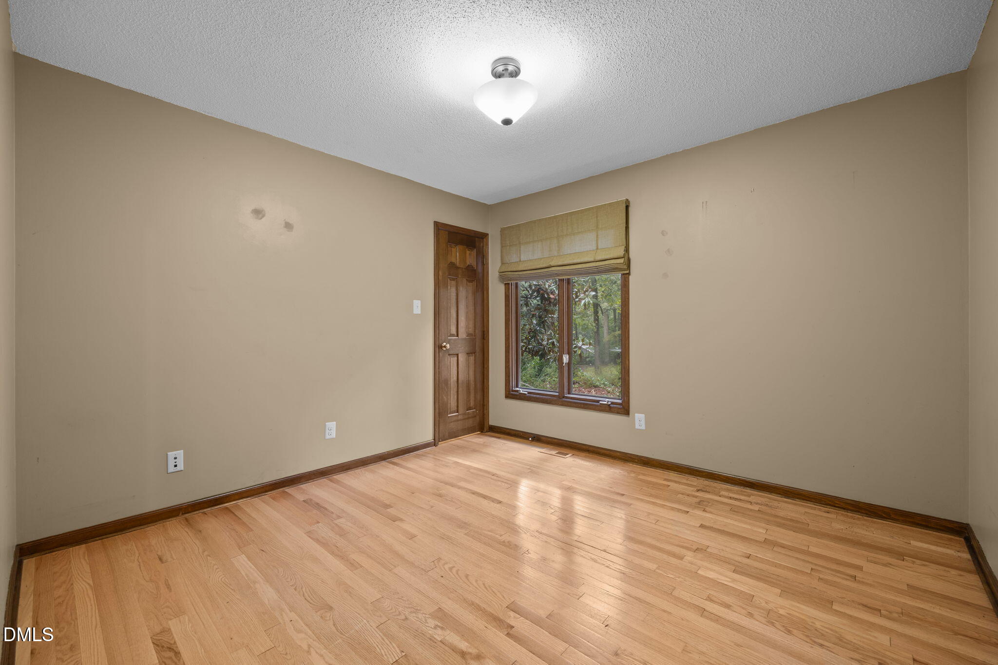 2713 Salisbury Plain Raleigh, NC 27613 - Photo 26 of 39 a view of an empty room with wooden floor and a window