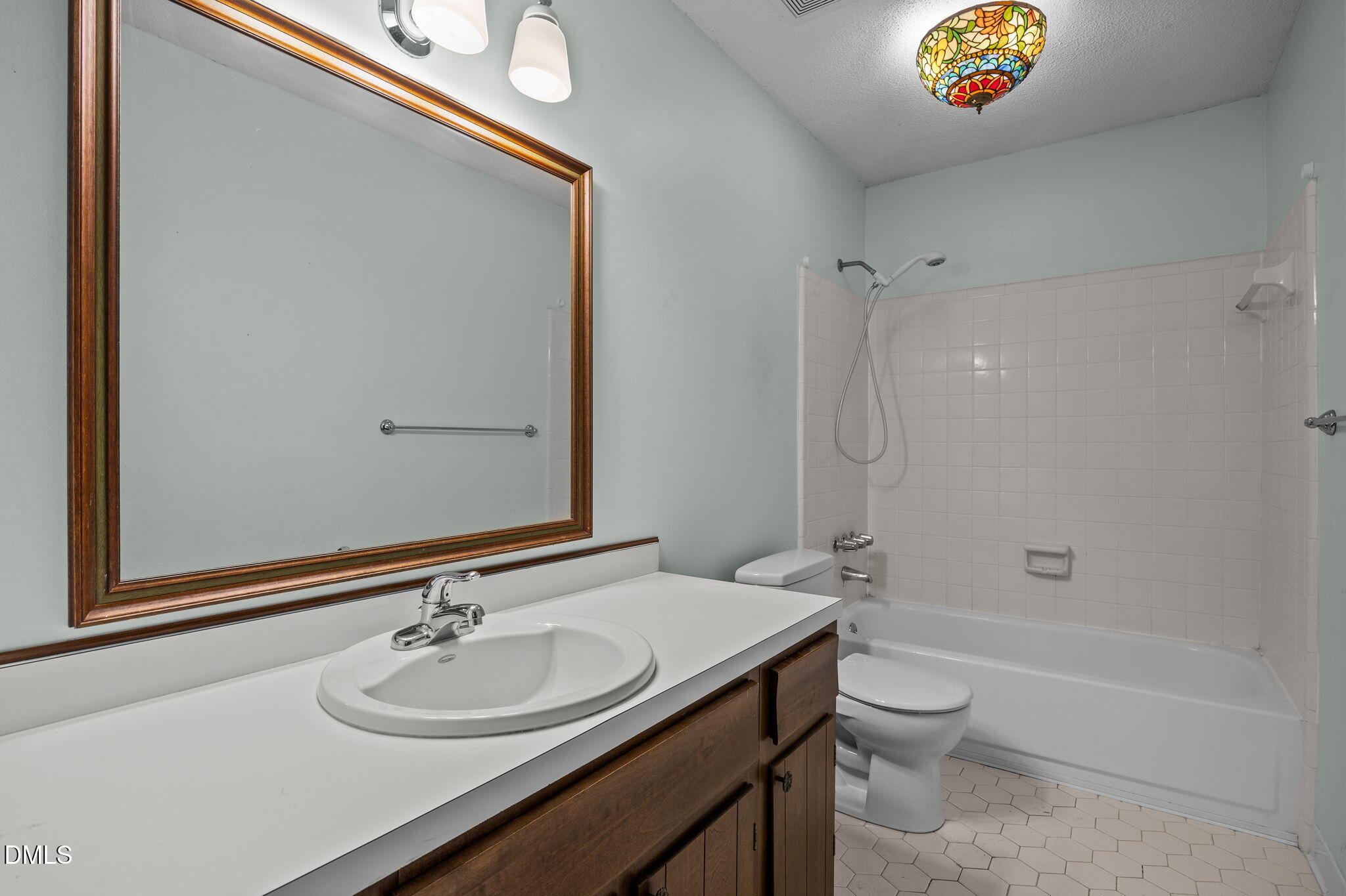 2713 Salisbury Plain Raleigh, NC 27613 - Photo 28 of 39 a bathroom with a sink a toilet and shower