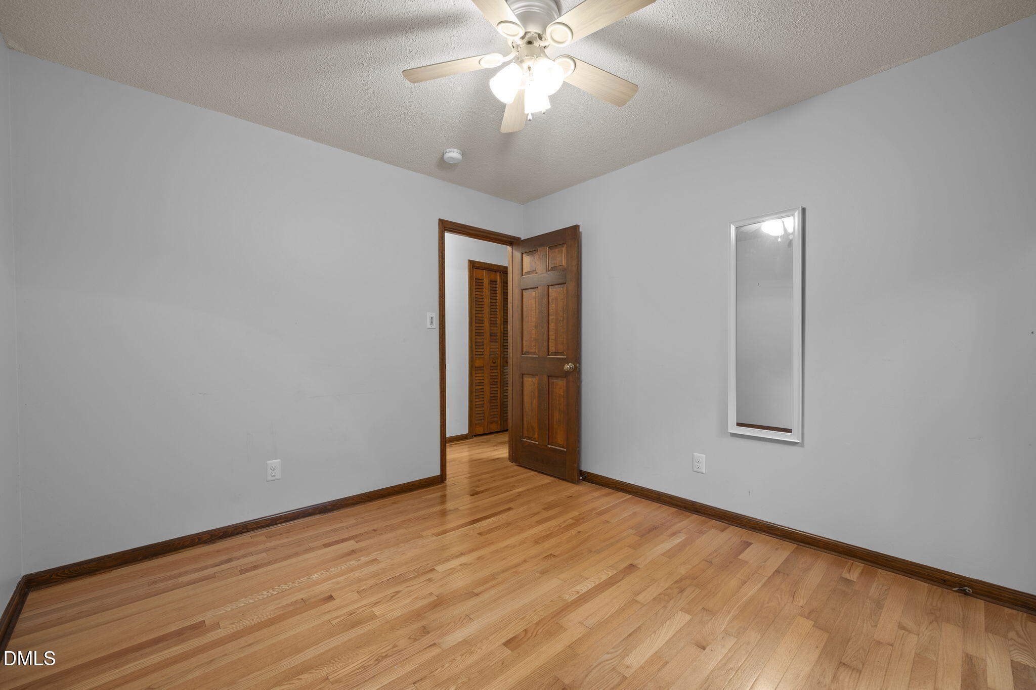 2713 Salisbury Plain Raleigh, NC 27613 - Photo 30 of 39 a view of an empty room with wooden floor and a window