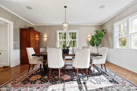 a view of a dining room with furniture window and wooden floor