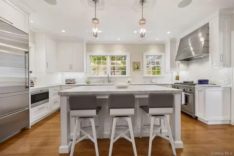a kitchen with granite countertop furniture window and stainless steel appliances