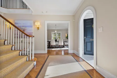 a hallway with wooden floor windows and livingroom