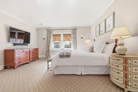 a bedroom with a bed and a tv