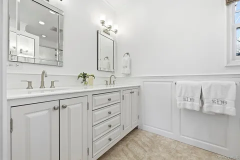 a bathroom with a sink vanity and mirror