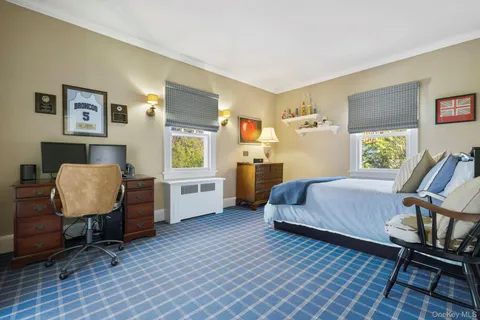 a bedroom with a bed and a chair in it